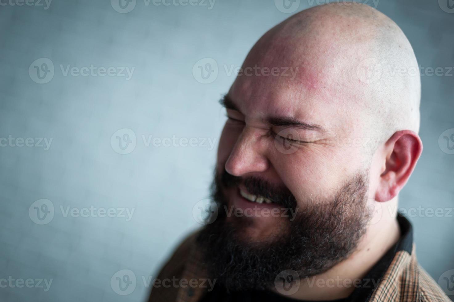Portrait of a bald man in a shirt with a beard photo