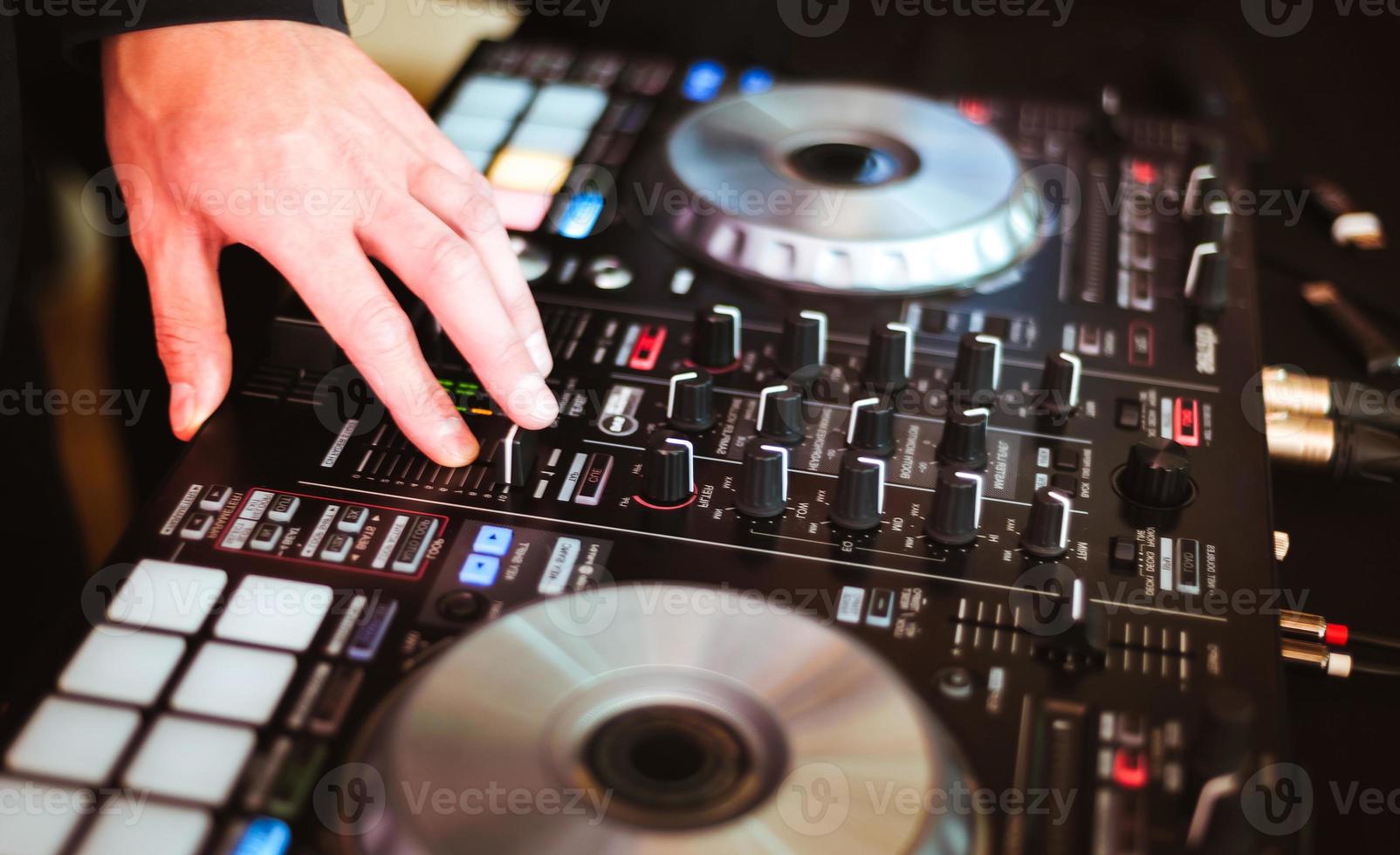DJ plays and mix music on digital midi controller photo
