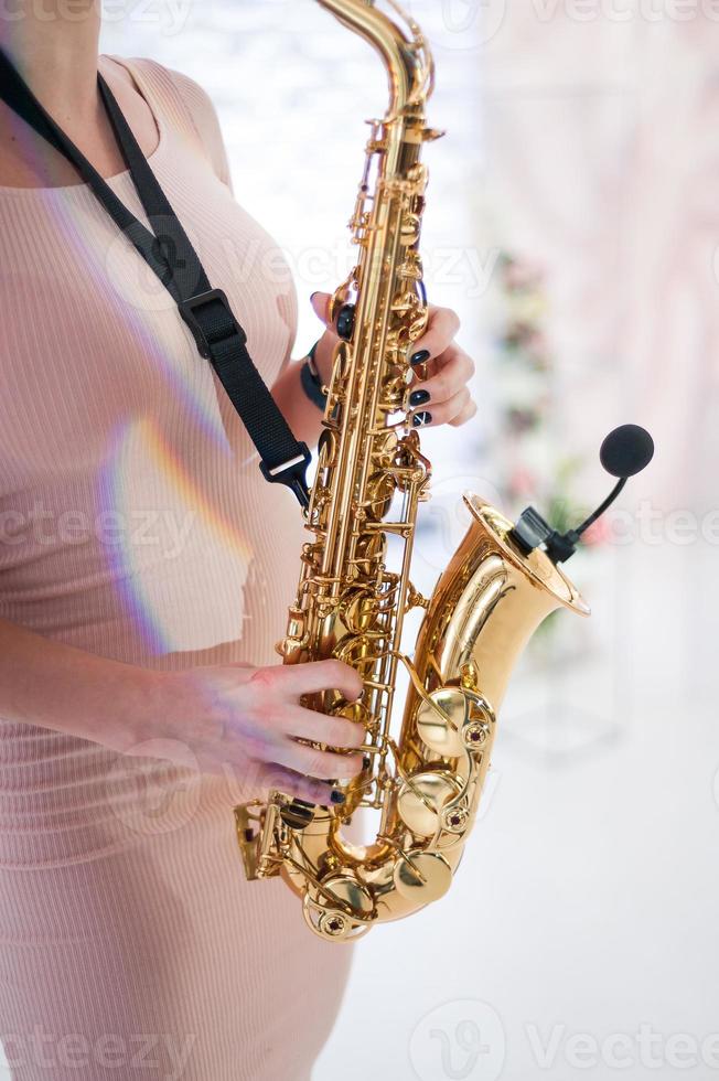 Beautiful girl playing saxophone photo