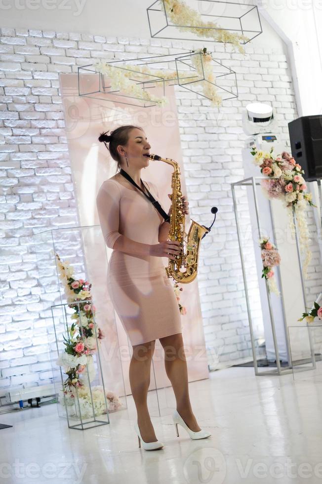 Beautiful girl playing saxophone photo