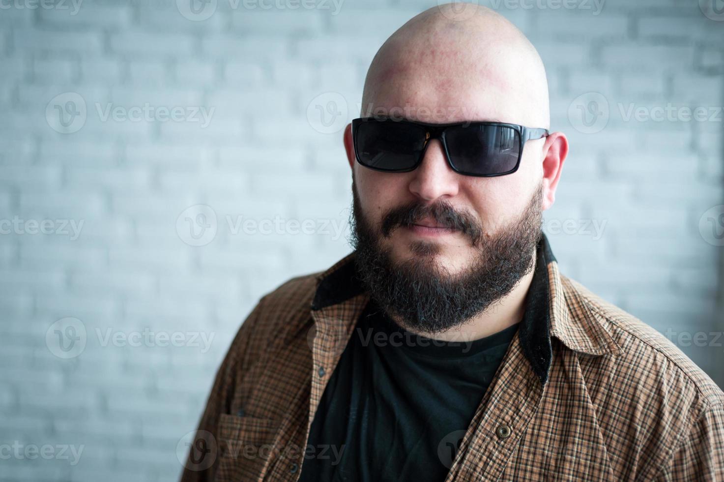 Portrait of a bald man in a shirt with a beard photo