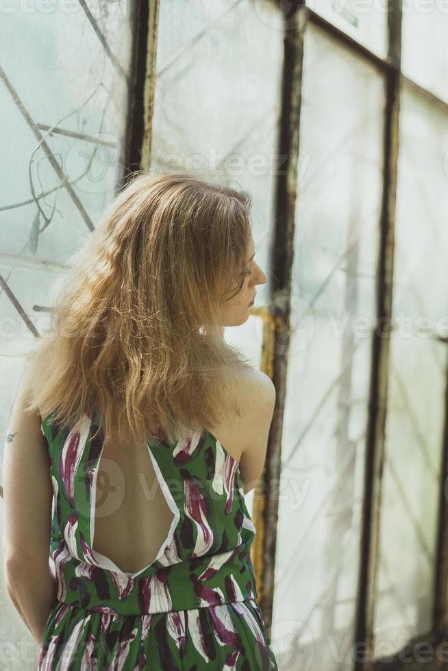 Pretty lady from behind standing by window scenic photography photo