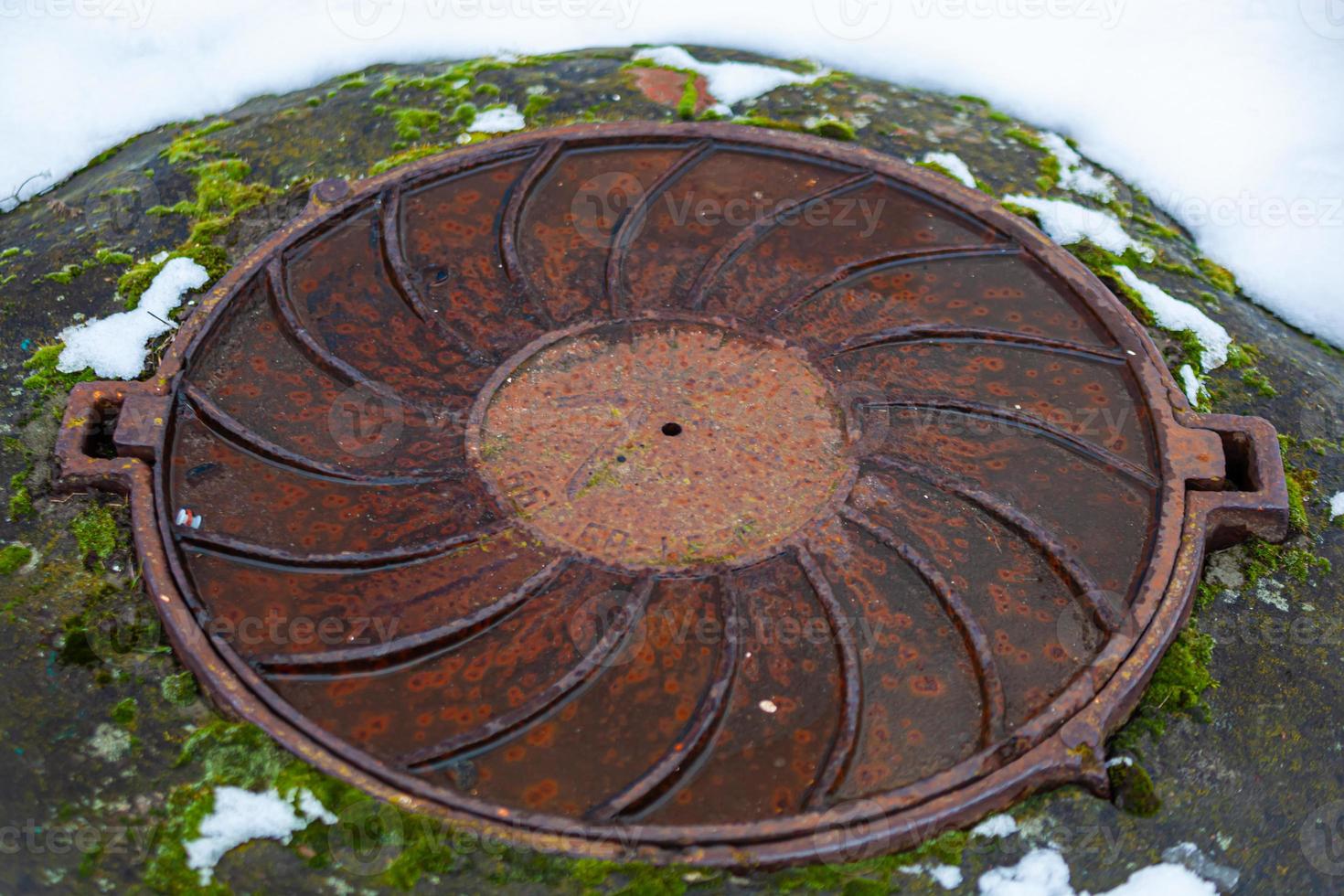 The manhole closes the city's sewage. Winter. Photo. photo