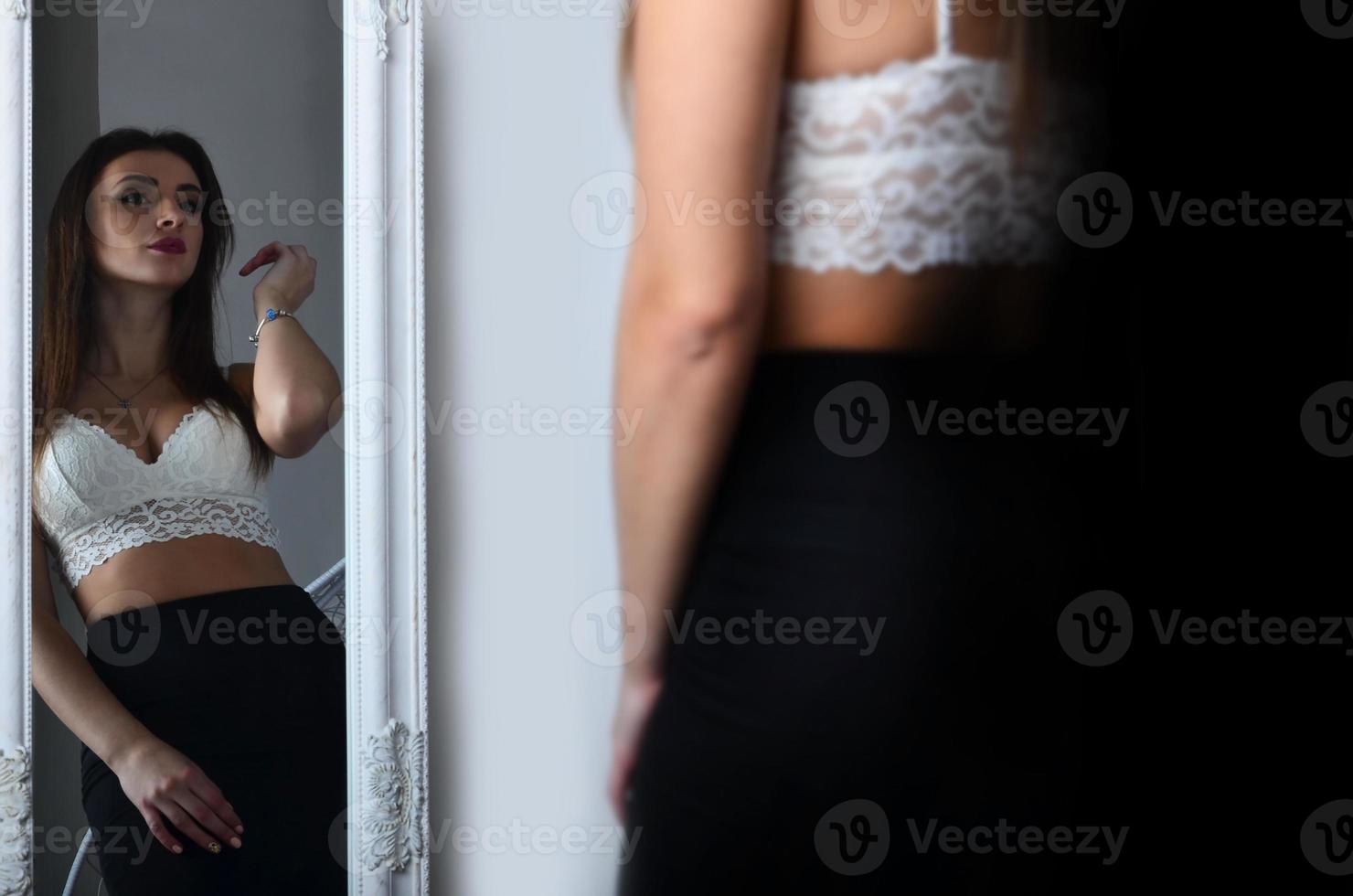 Young beautiful girl and mirror photo