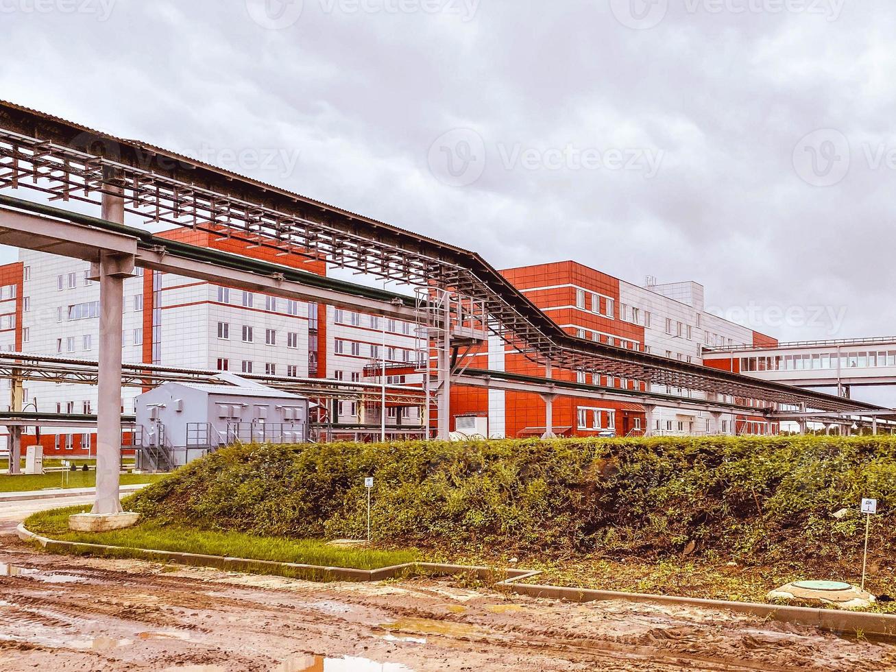 construction of a new complex at the plant. metal structures erected over a person's head. pipeline for moving oil and gas resources photo