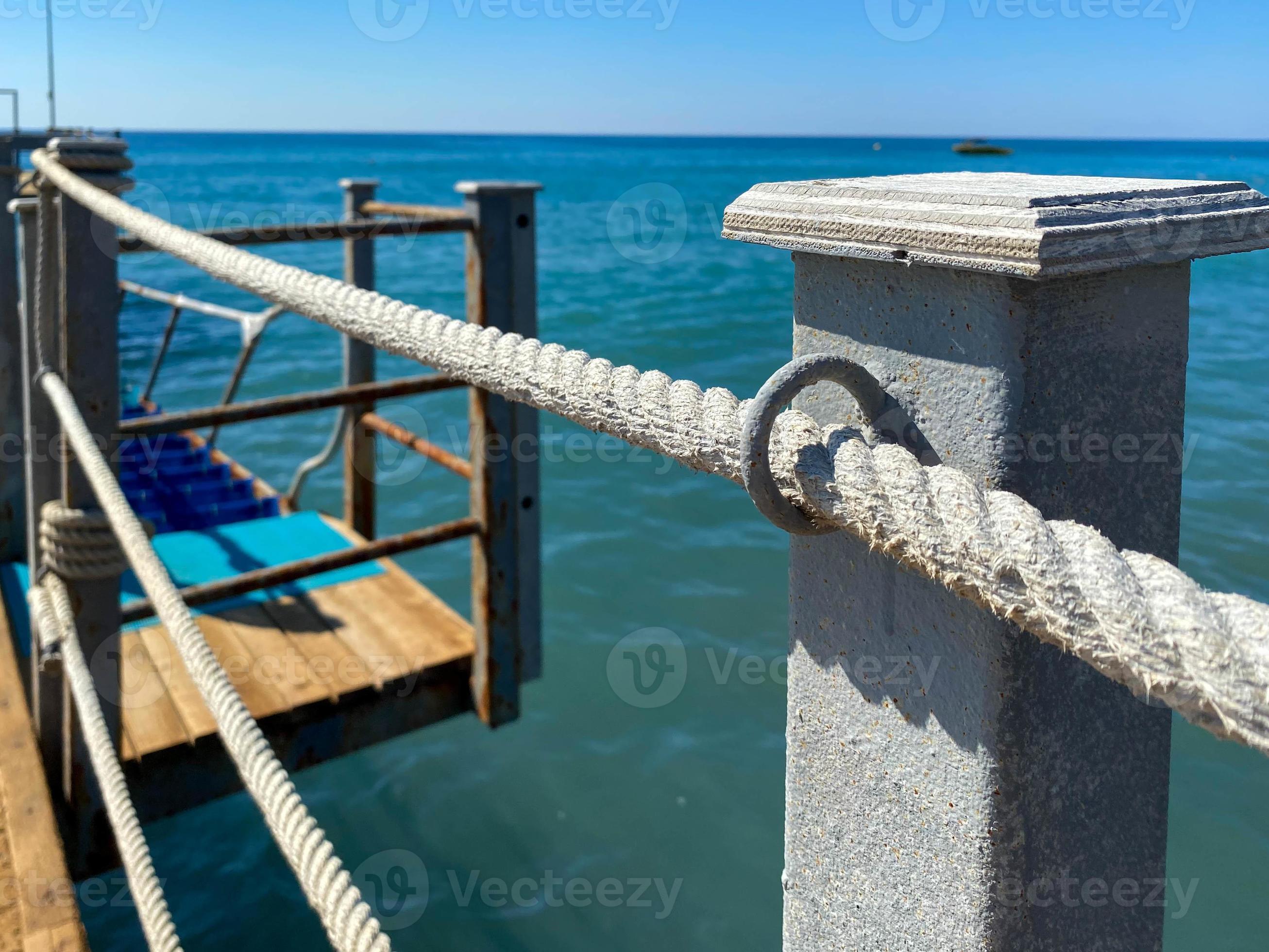 A wooden long pontoon, a pier with a rope railing on the sea on the beach  on vacation in a paradise warm eastern tropical country resort 15539661  Stock Photo at Vecteezy