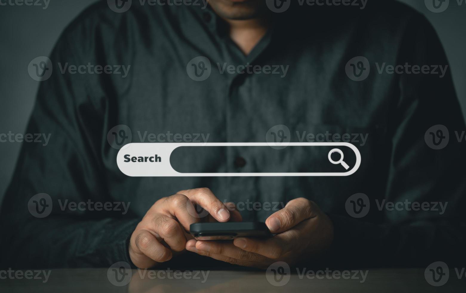 Businessman use mobile phone searching browsing internet data information with blank search bar. Search engine optimization SEO networking concept. businessman working with smartphone on desk. photo