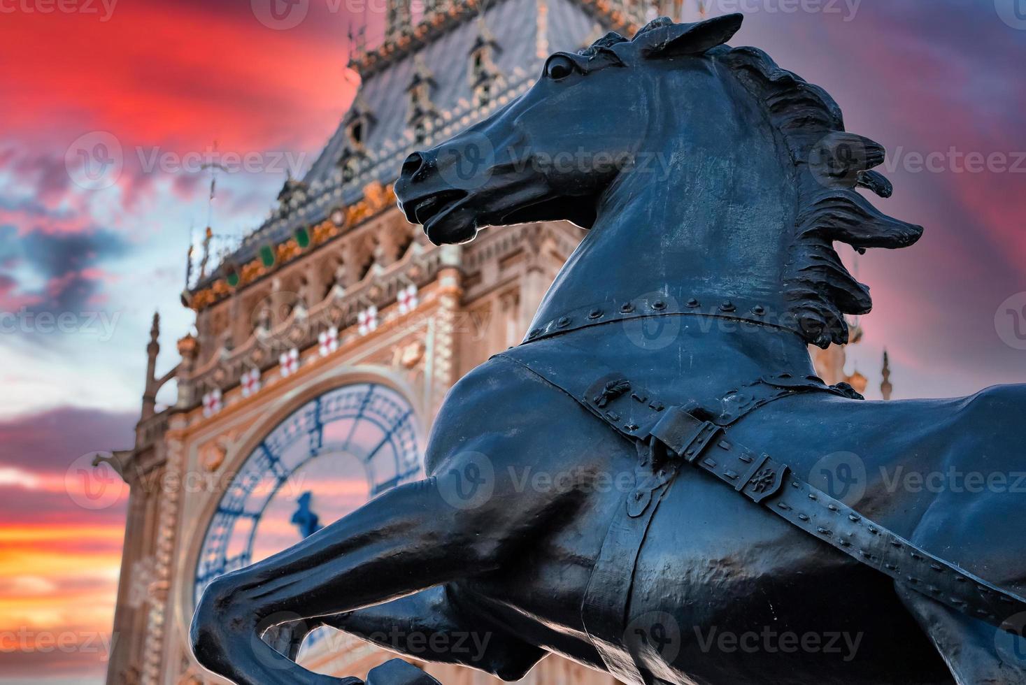Close up view of the Big Ben clock tower and horse statue monument in the foreground. photo