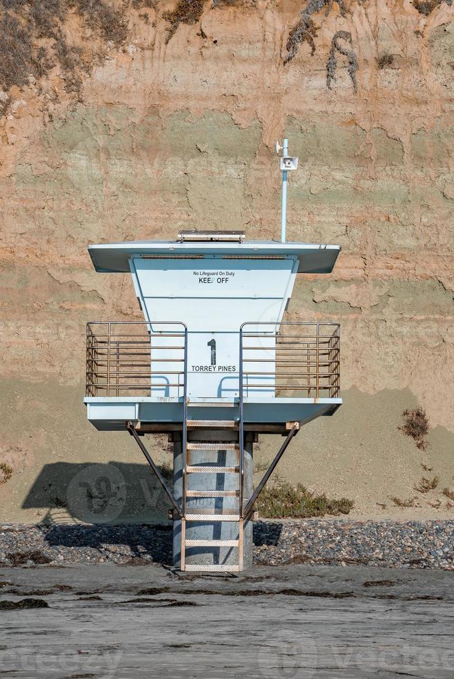 Empty lifeguard tower at beach with mountain in the background photo