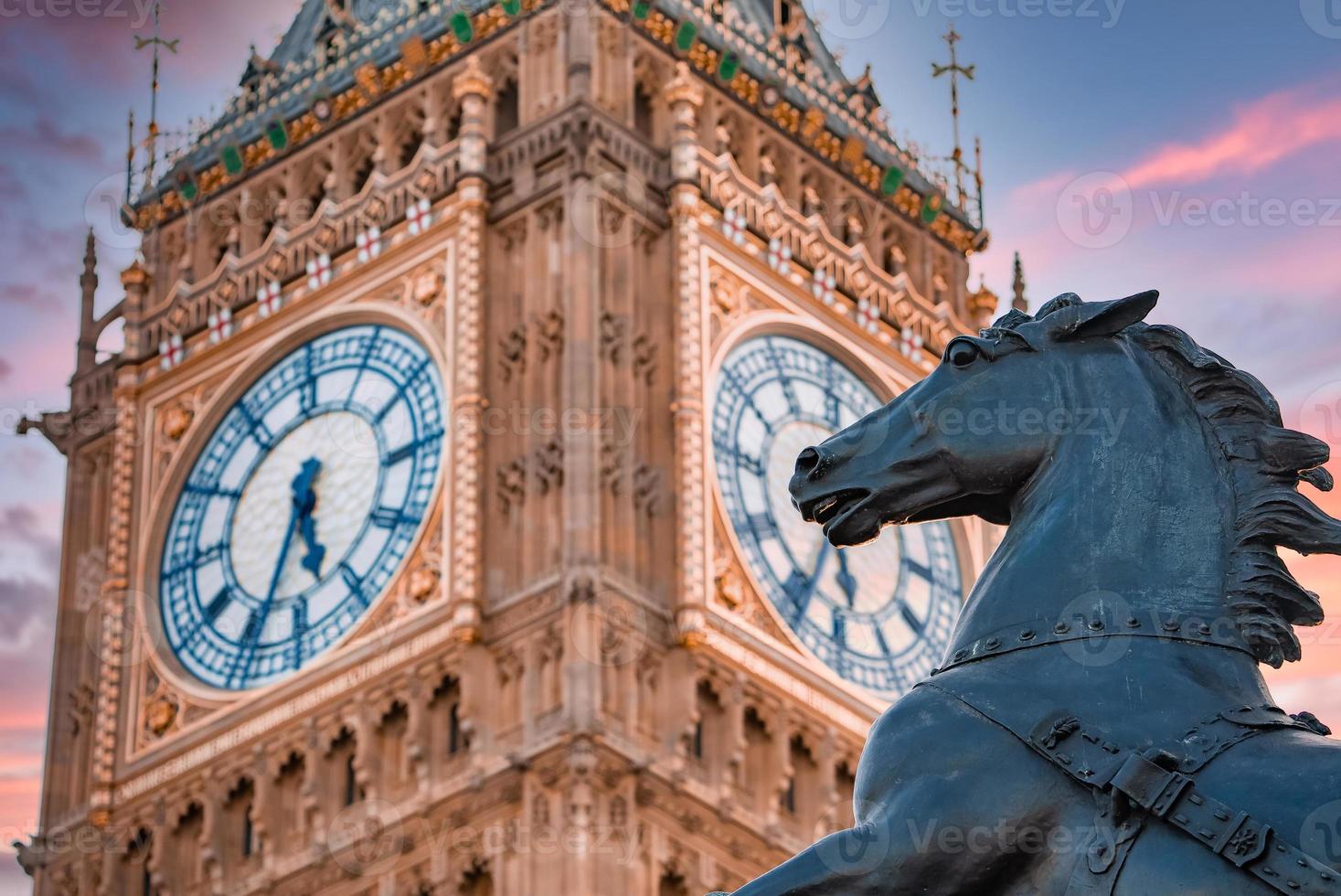 Close up view of the Big Ben clock tower and horse statue monument in the foreground. photo