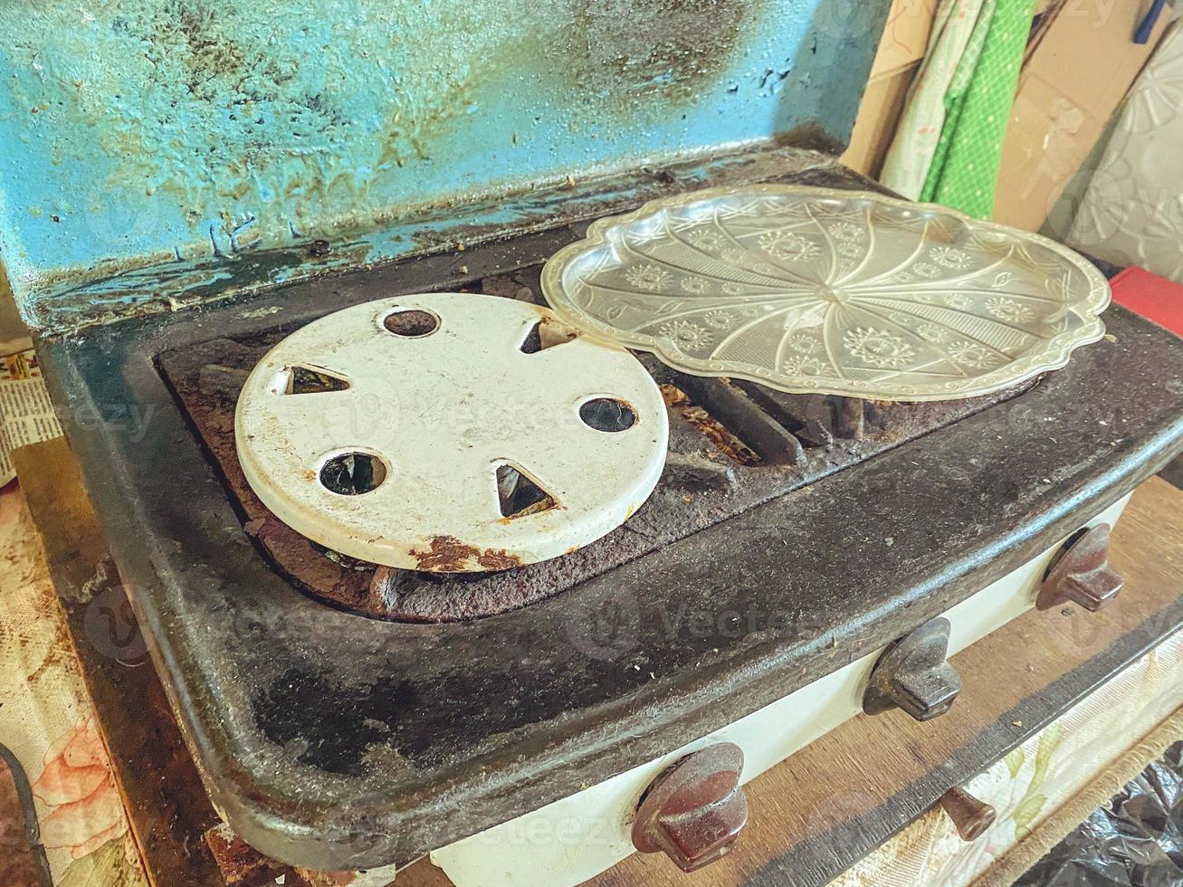 old gas stove for cooking. burners for gas, pans. two places for cooking. garden appliances for the kitchen. small stove photo