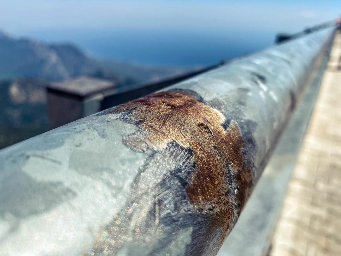 metal texture. observation deck with railings. the fence was corroded from old age. gray metal pipe with rusty smudges photo