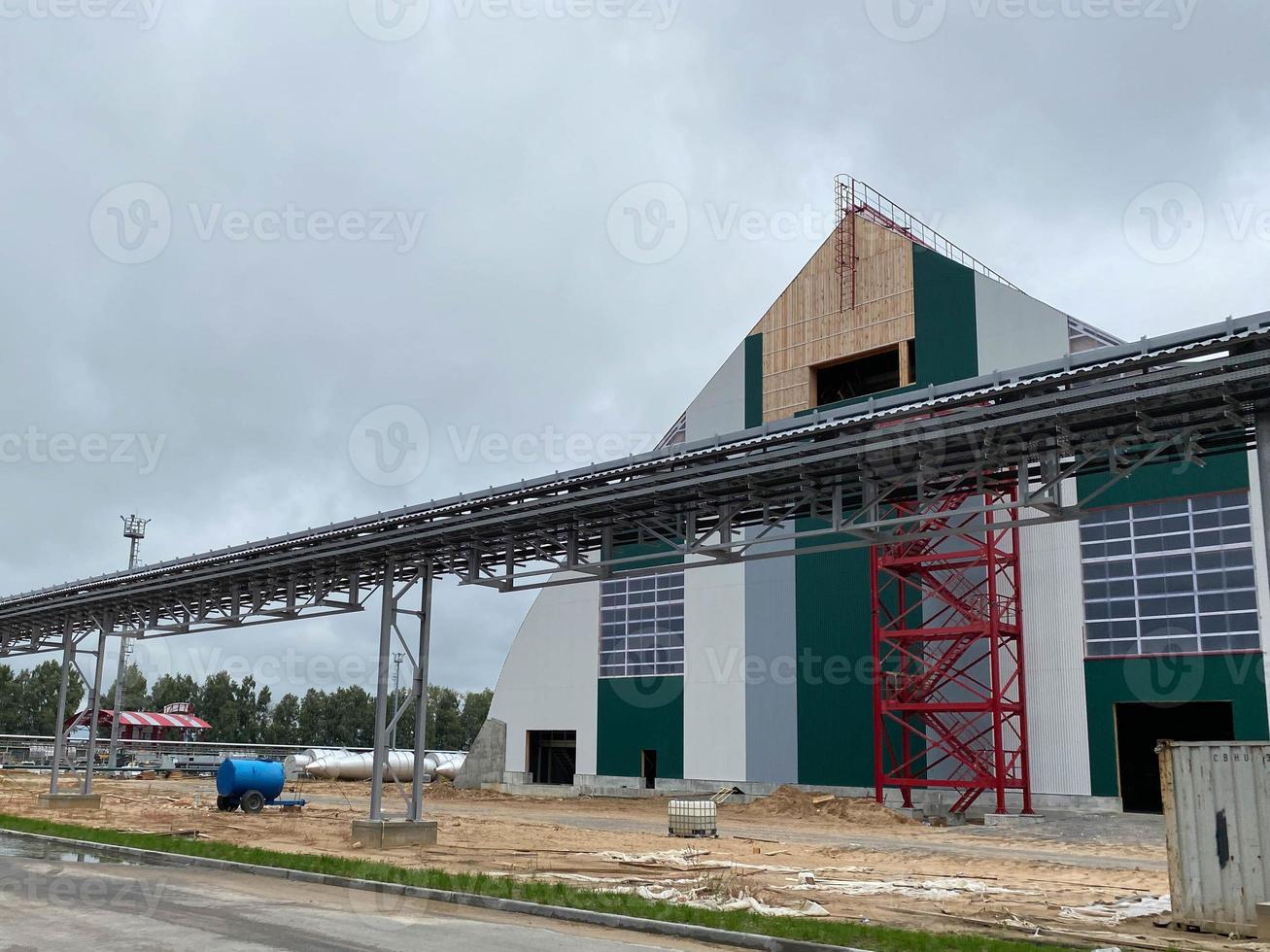 Metal frame of the building with a sandwich panel of insulation on the wall. Construction of a new industrial building. Modern Insulation of the walls of the building panels of insulation photo