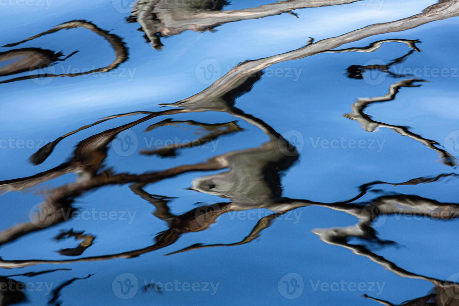 Reflection in Water on a Blue Background photo