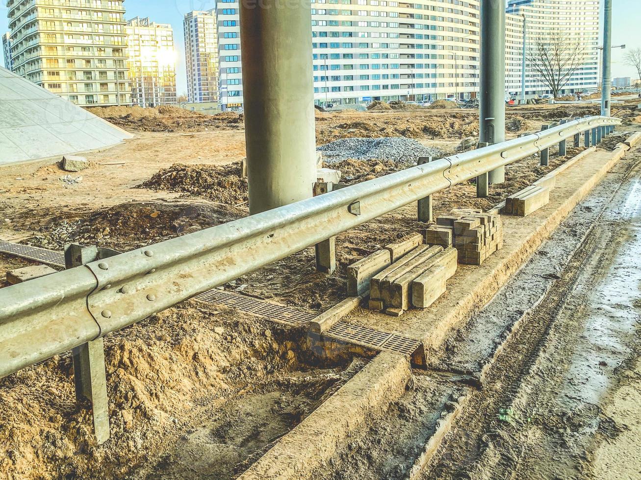 bridge in the new neighborhood. concrete bridge on beams, near dirt, puddles. bridge construction. construction of infrastructure in a new microdistrict photo