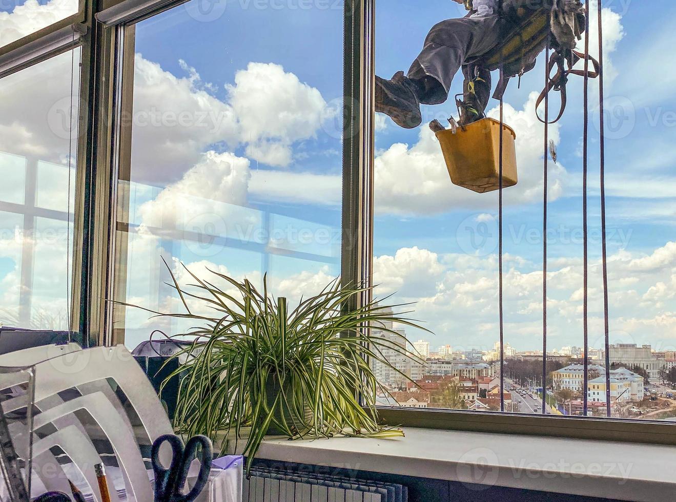 Window washer on side of office building, close-up. photo