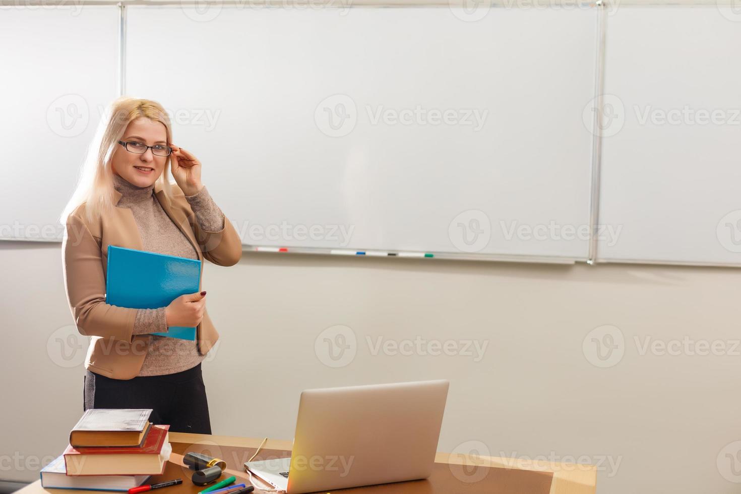 smiling teacher and slate blackboard background photo