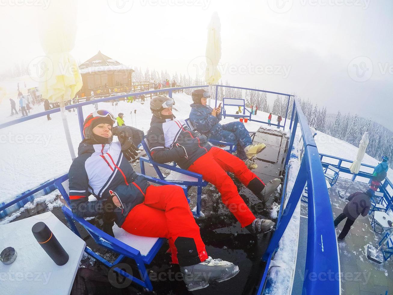 Skier relaxing at sunny day on winter season with blue sky in background photo