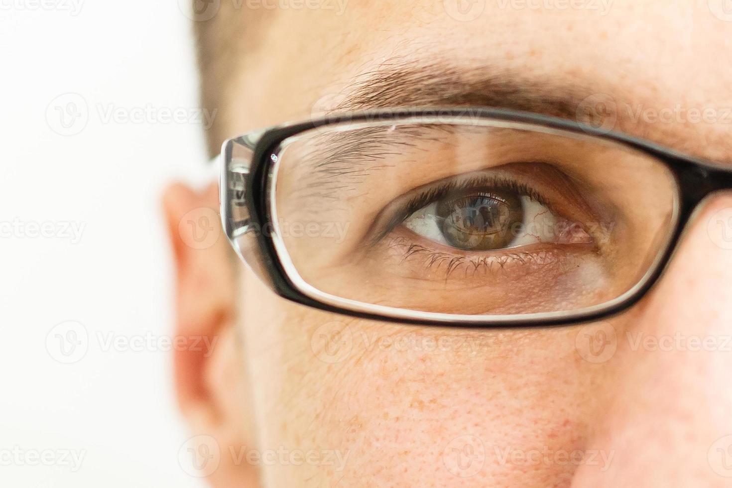 Young man puts his glasses on photo