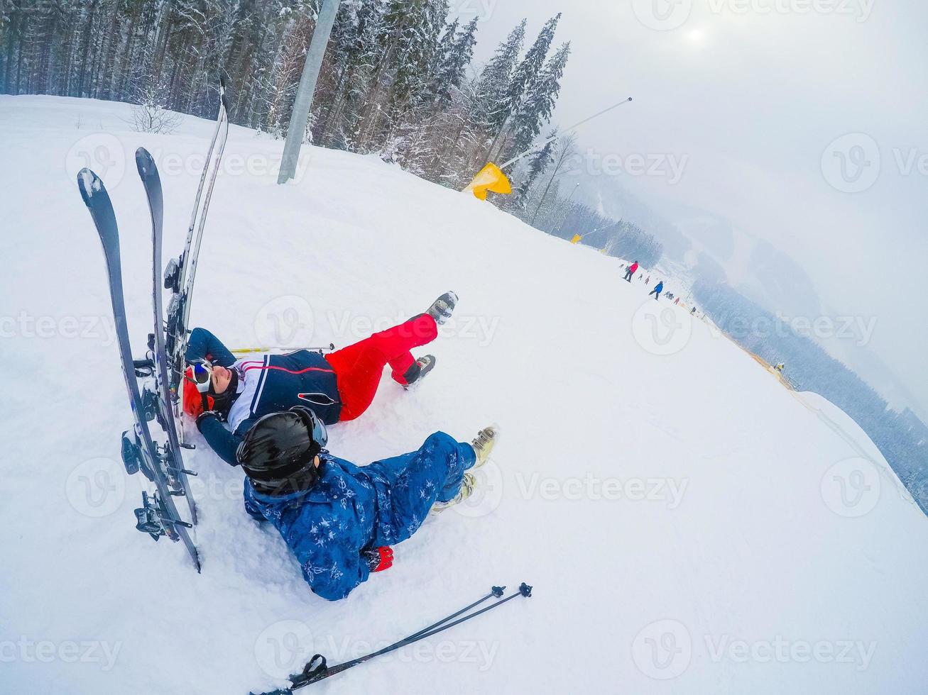 Skier relaxing at sunny day on winter season with blue sky in background photo