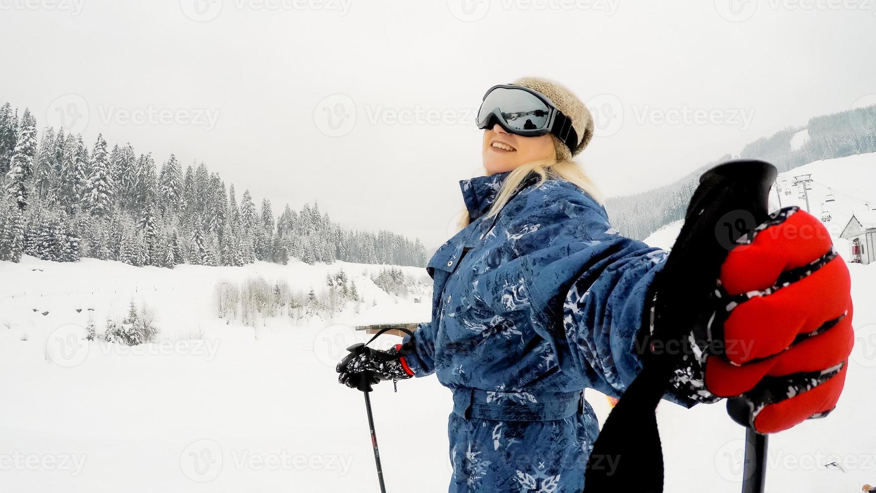 mujer joven con puesto de esquí en tom of the hill foto