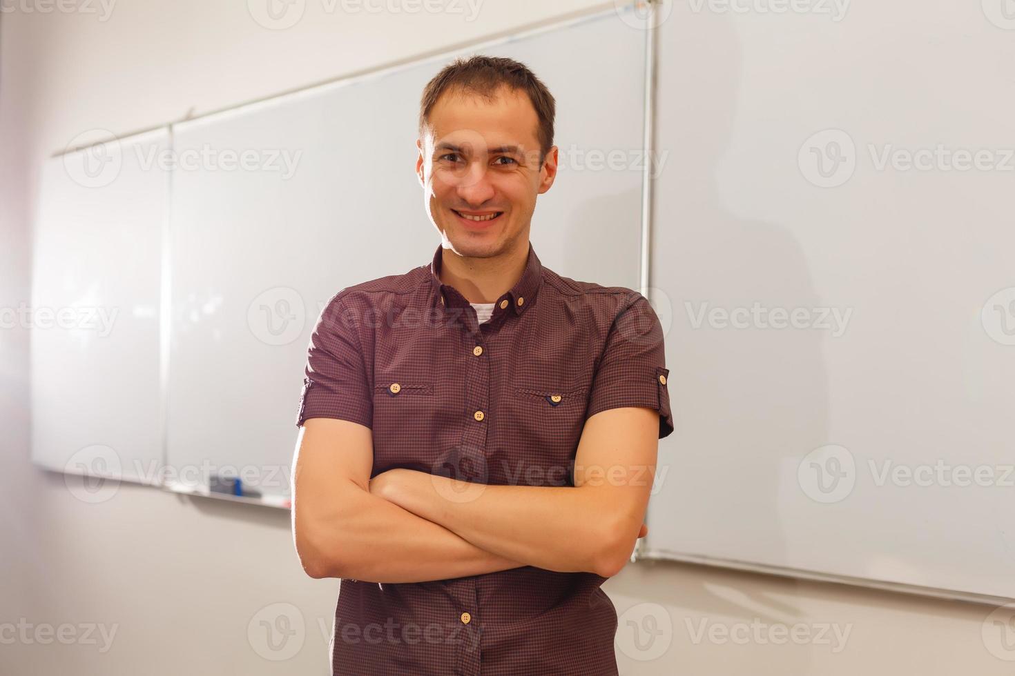 Male teacher listening to students at adult education class photo