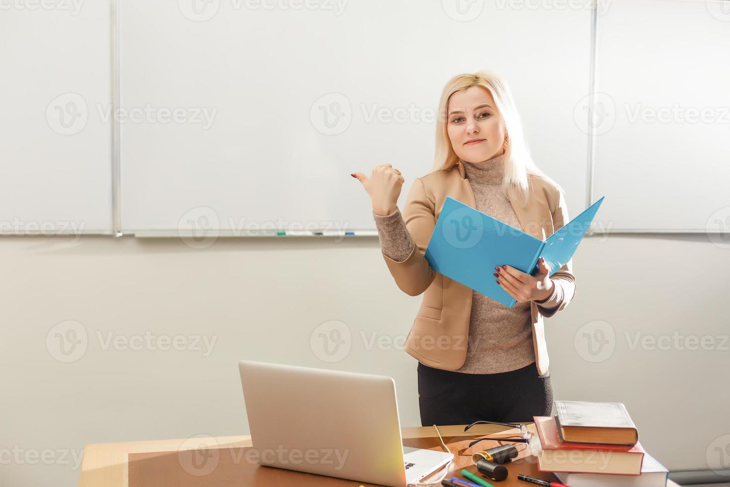 smiling teacher and slate blackboard background photo