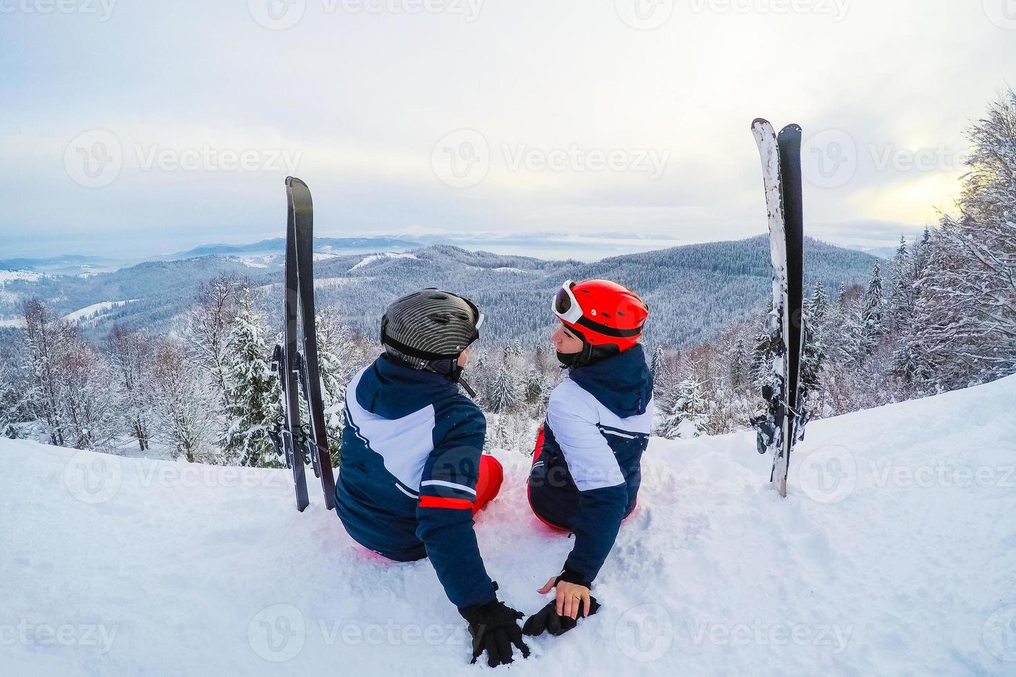 Skier relaxing at sunny day on winter season with blue sky in background photo