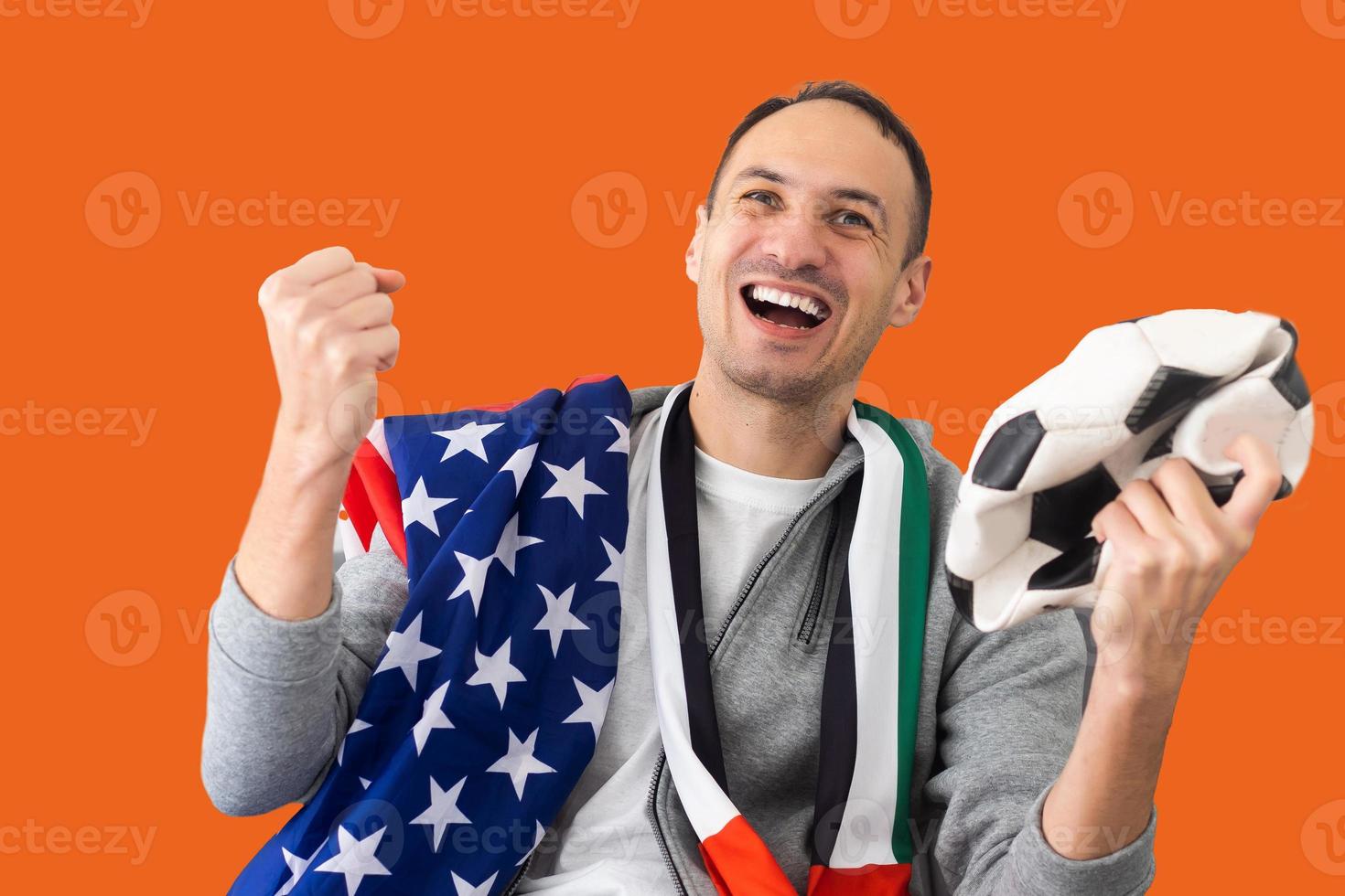 male football fan with a crumpled ball and with the flag of the UAE and the USA photo