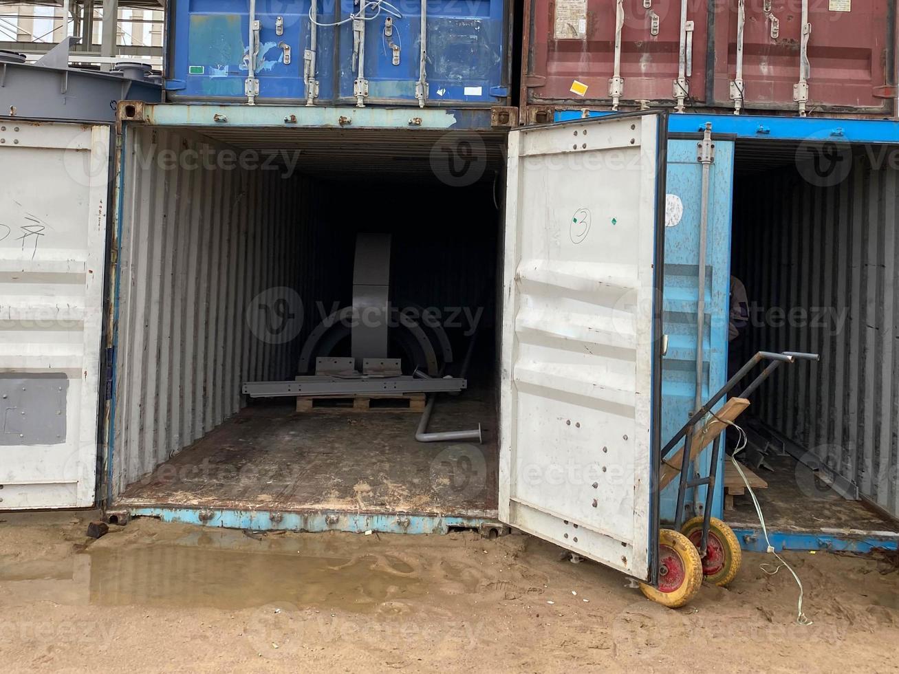 Multi-colored iron industrial sea containers for international transportation of goods according to the logistic rules of Incoterms 2010 DAP and DDP photo