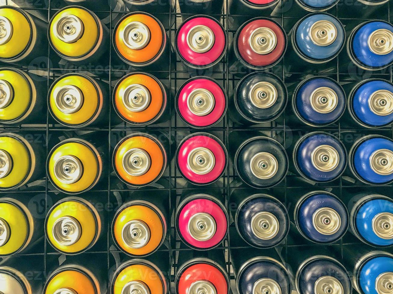 spray cans of paint are on display. paint sprayers of various colors. graffiti art, car painting. balloons filled with colorful dyes photo