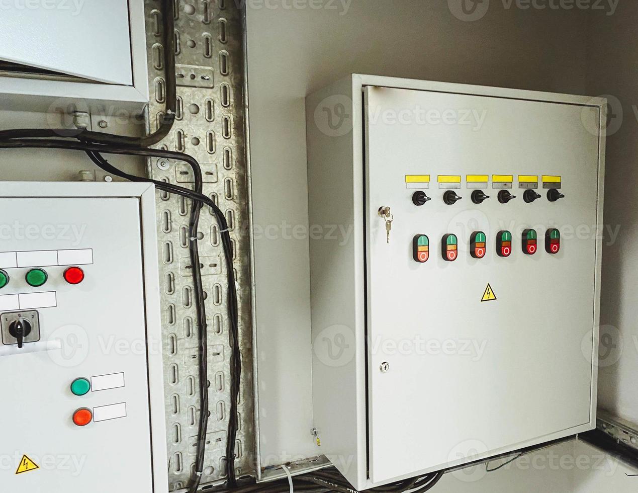 Electrical room of residential or commercial building. Multiple smart meters, main power breaker, meter stacks and cabinets. Perspective view. photo