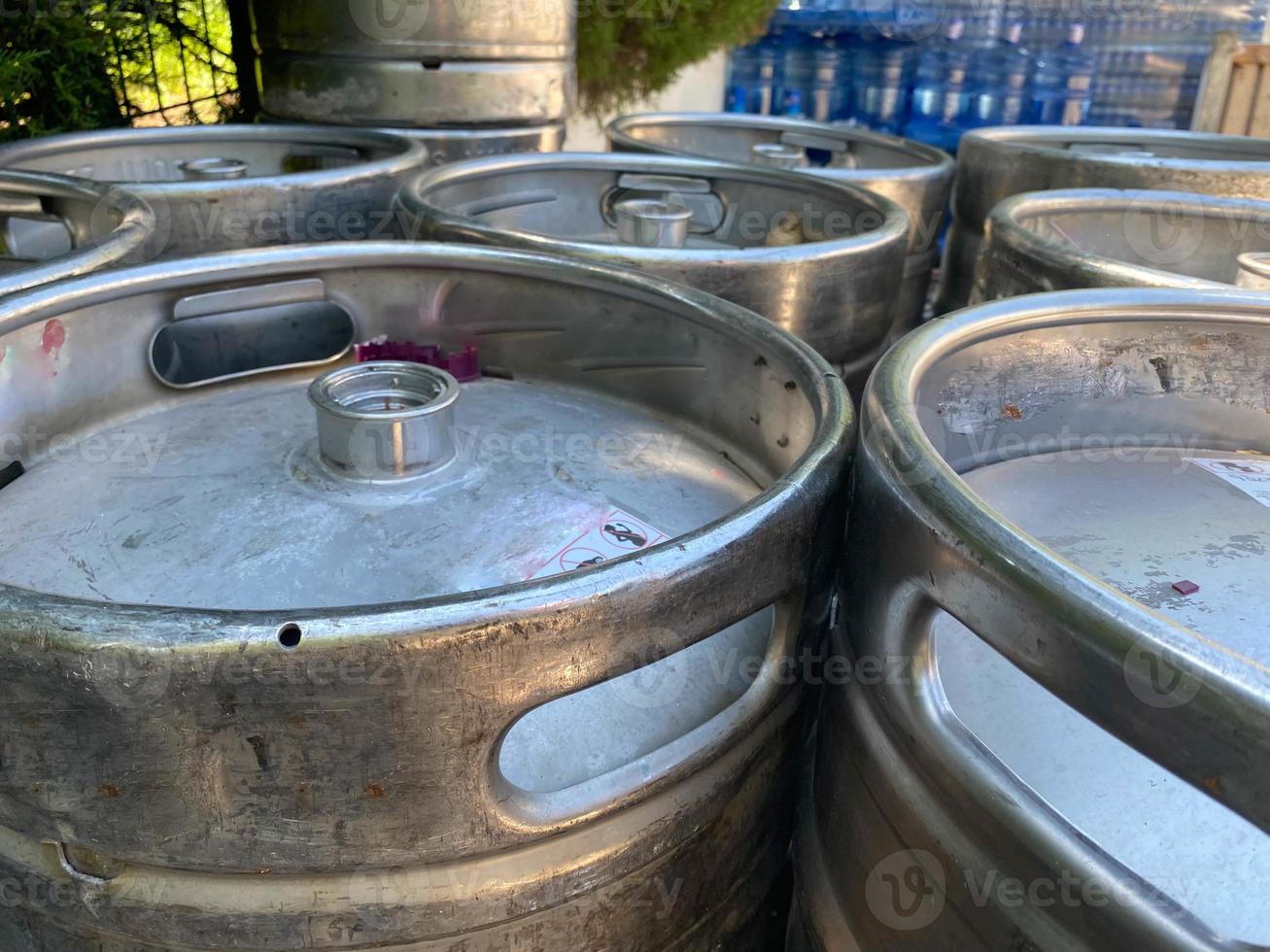 metal barrels at a construction site. large containers for liquid and bulk materials. safety of barrels at the construction site. rust gray glossy paint photo