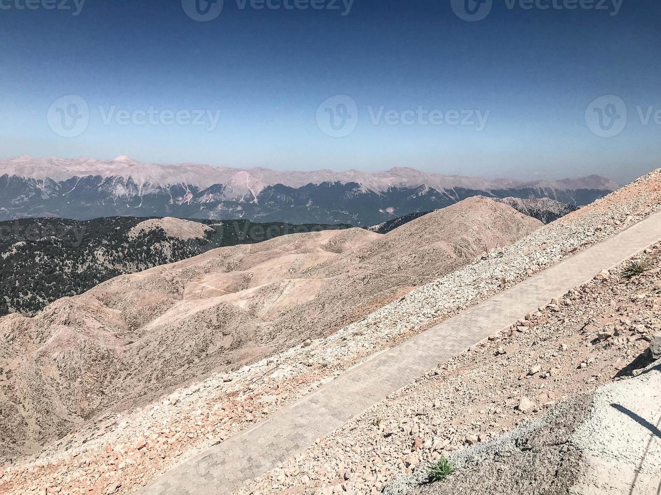 sandy mountains with green plants. beautiful, travel to an exotic country, tourism. mountains under the clouds, trails for tourists, climbing photo