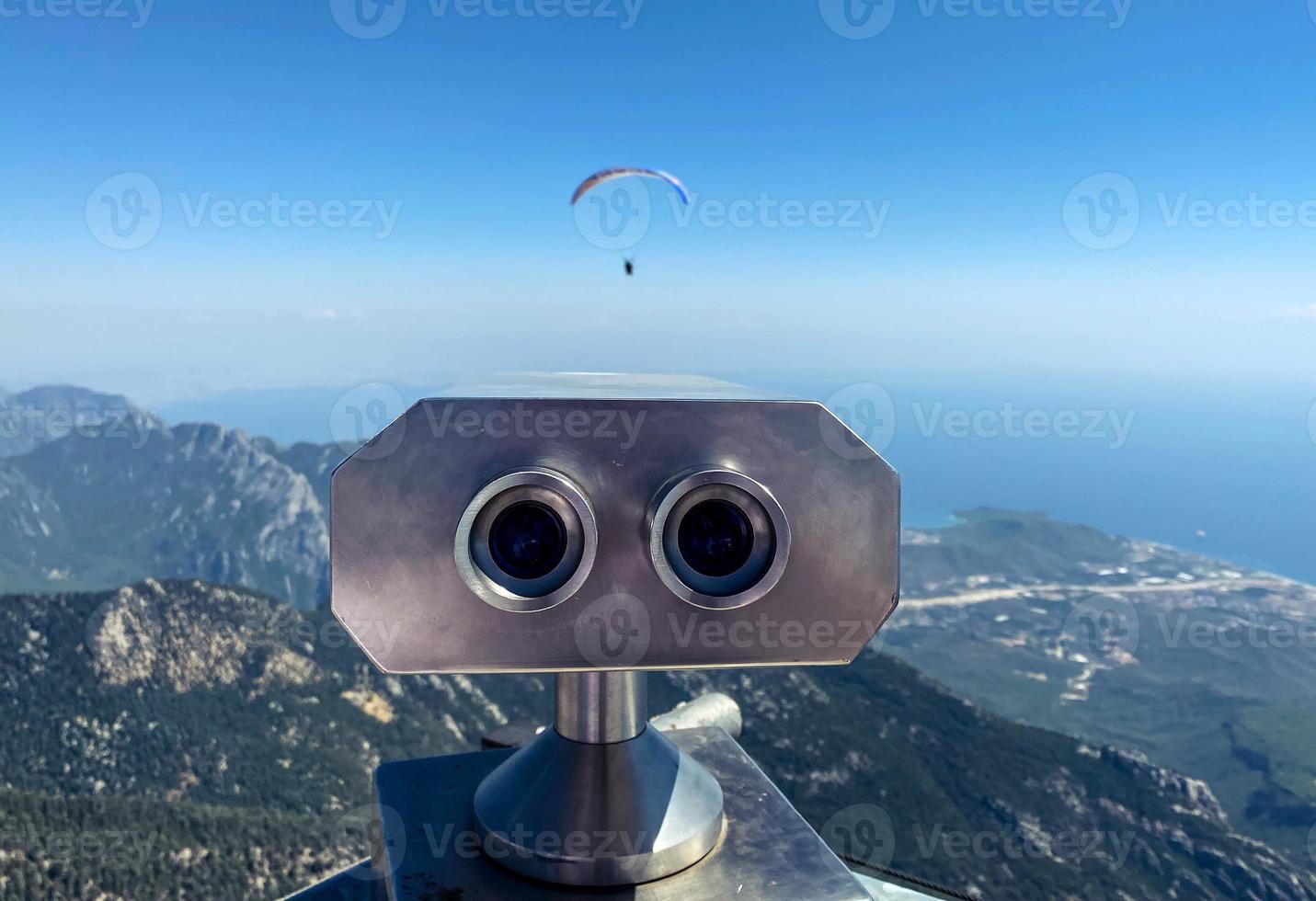 observation deck with binoculars. large, metal magnifier of the surrounding world. panoramic binoculars for tourists, observation of skydivers photo