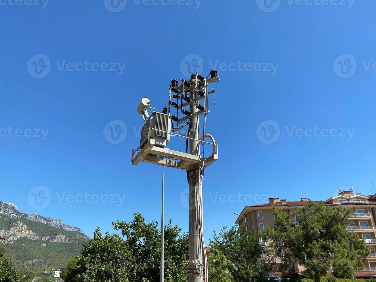 pole with electric transformer and high voltage electrical cable photo