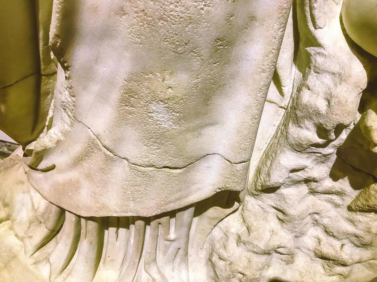 three-dimensional texture, plaster sculpture, ancient art. on the texture of scuffs, chips, cracks. sculpture in the form of a human neck with cracks photo
