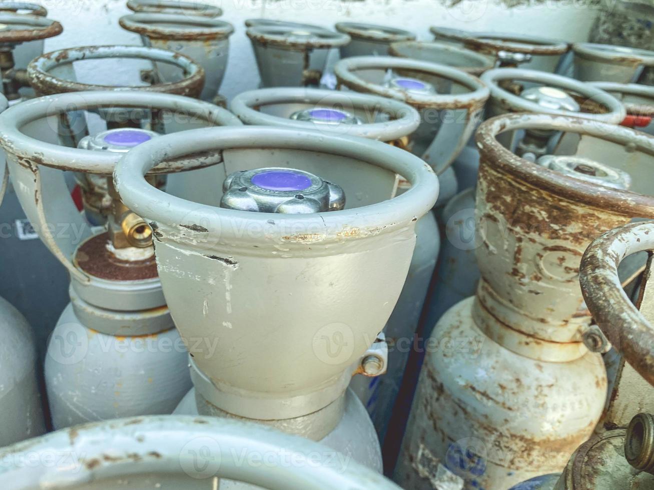 metal barrels at the construction site, fire cylinders. large containers of gases with a shutter. barrels have a screw cap with a blue center photo