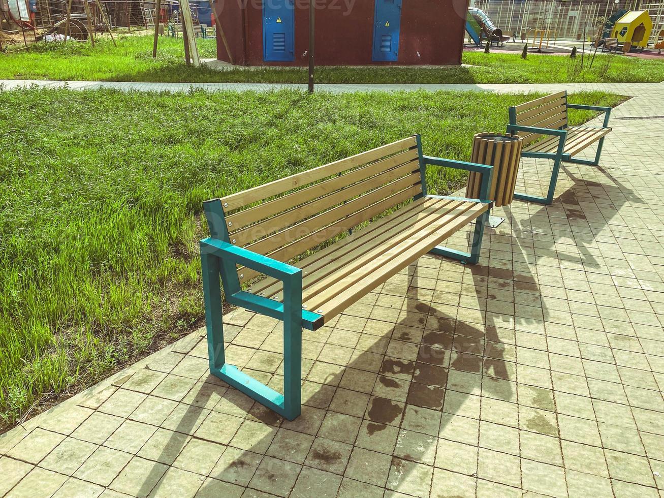 wooden bench in the park on the street. recreation of people outdoors. seats made of natural materials for the rest of tired tourists photo