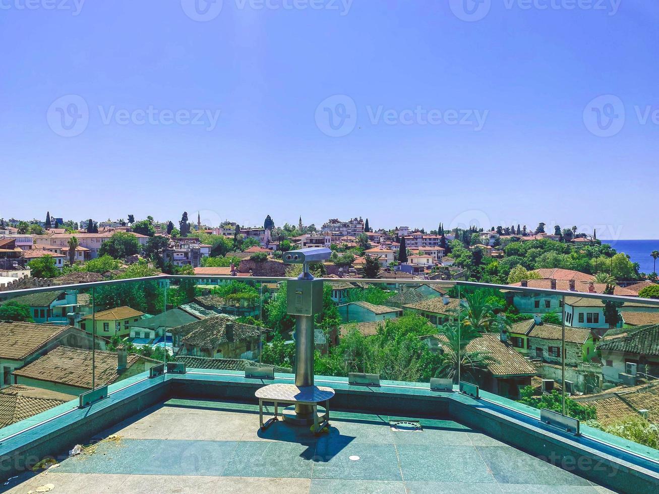 observation deck in the city center. binoculars for tourists are installed on the roof. at the height of the houses of local residents with a tile roof photo