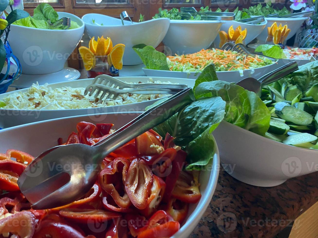 Green vegan salad from green leaves mix and vegetables. Top view on gray stone table photo