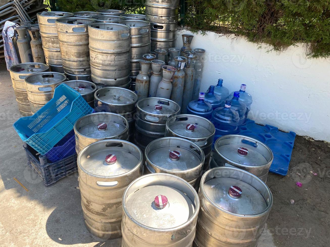 beer kegs. many metal beer keg stand in rows in a warehouse. photo