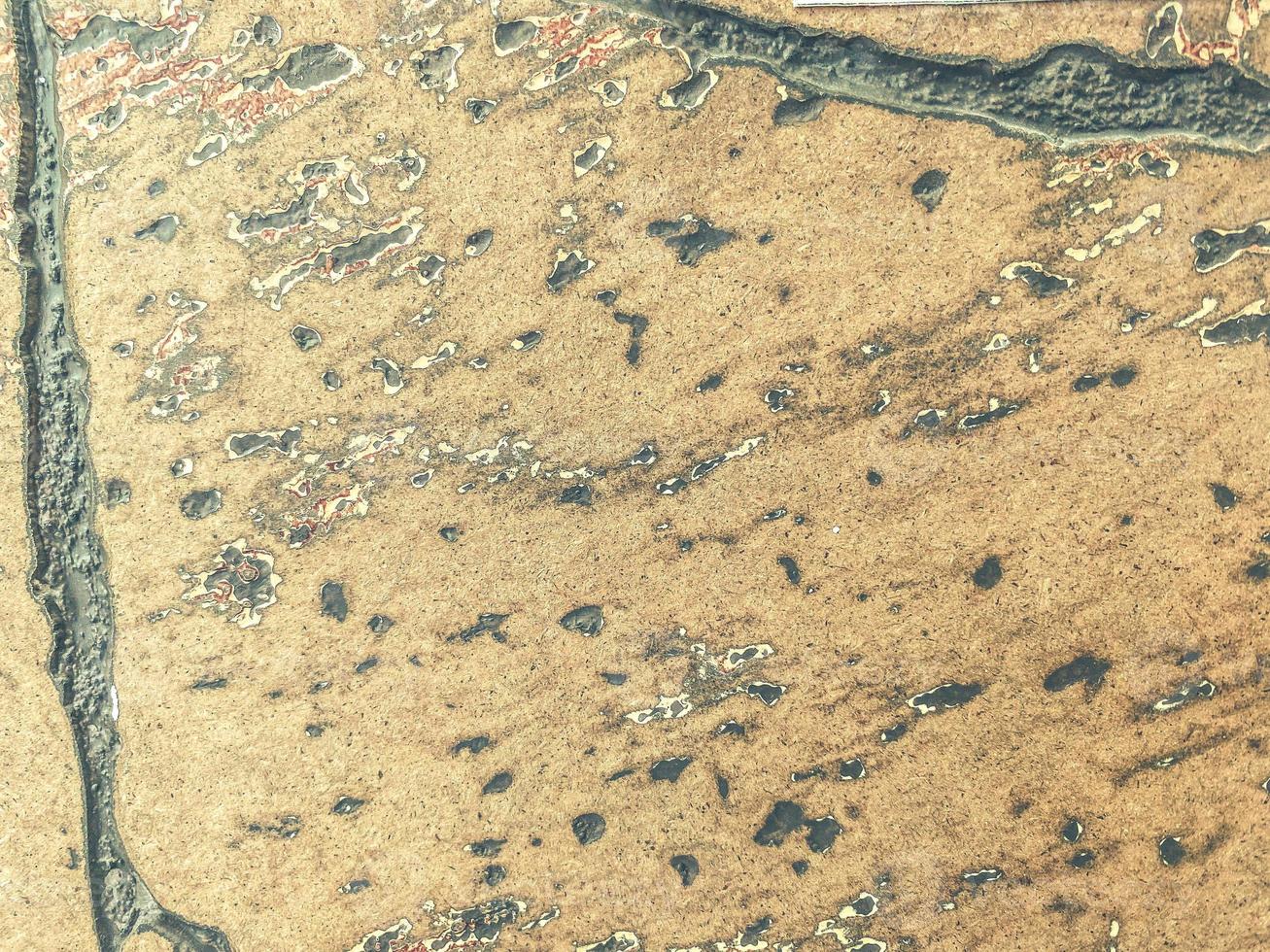 stone texture, unusual pattern on natural material. volumetric 3D texture, beige stone with gray patches. small drawing on the rock photo
