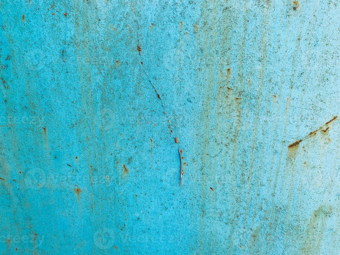 blue texture, metal wall painted in blue paint. the background. peeling, old paint on the metal, traces of corrosion and damage. old texture, retro style photo