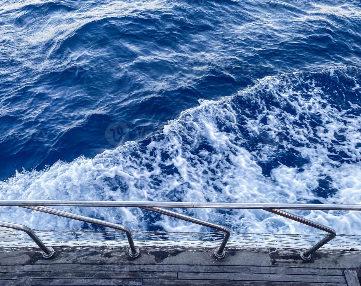 walk on the open sea. the yacht is equipped with metal sides for the safety of tourists. holidays in hot countries. blue waves of the sea, bubbling white foam photo