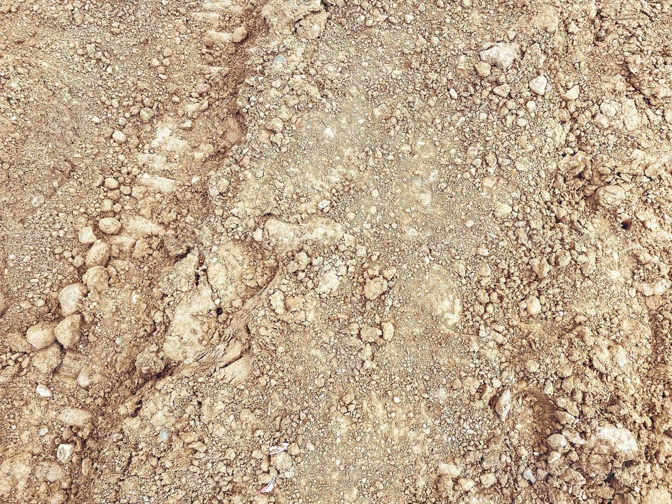 sand at the construction site of a new residential complex. texture, background. fine sand with stones from the ditch. the earth is lumped together photo