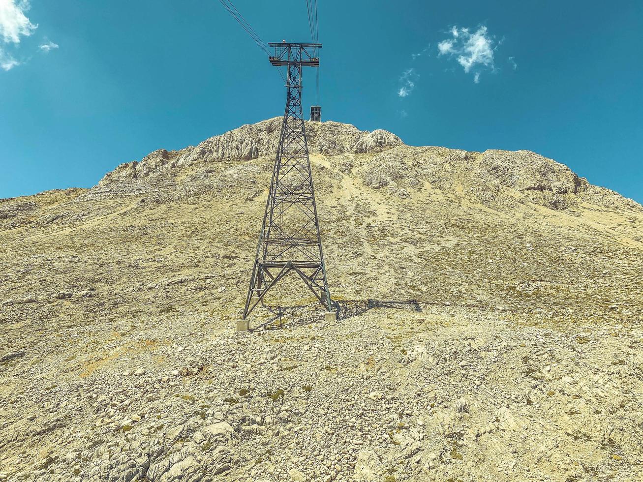 cable car on the mountain. a building for boarding tourists in the cabin before the tour. observation deck on the mountain, the power line supplies the road with energy photo