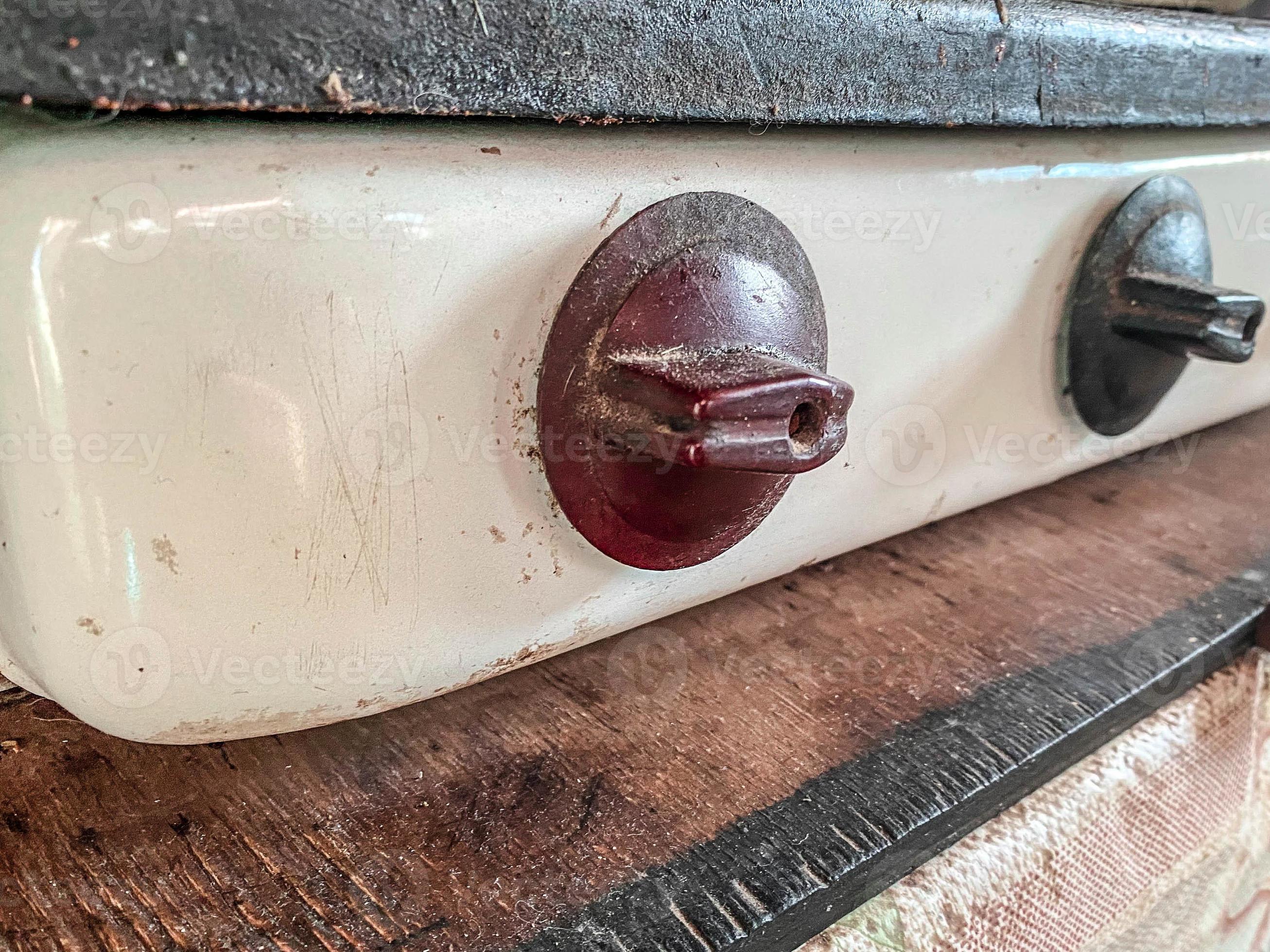 old gas stove for cooking. gas burners. adjusting the gas supply to the