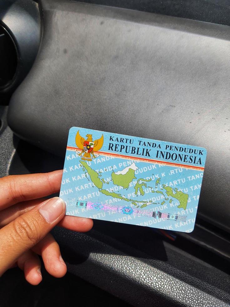 Central Java, Indonesia in October 2022. A hand holding an ID card. This KTP is issued by the Indonesian resident registration service. photo