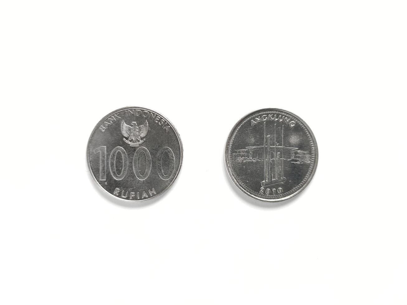 Indonesian's Rupiah coin with value 1000 Rupiah released in 2010 with symbol Angklung. Angklung is Indonesian traditional musical instrument. Taken from front and back view photo